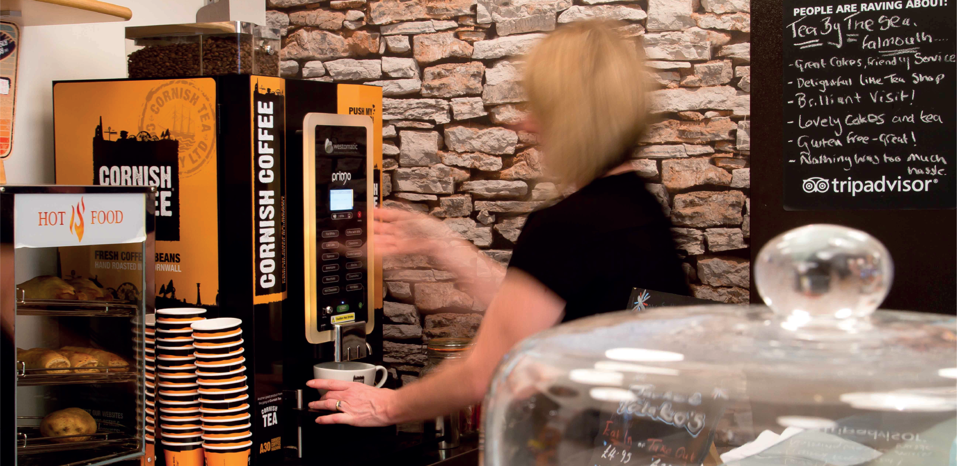 Image of barista using a Cornish Coffee Bean to Cup Machine